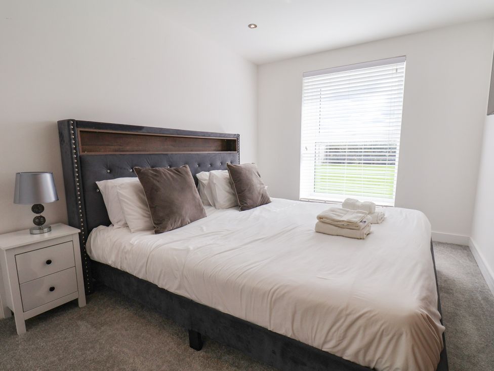 A bedroom with a bed and a nightstand at Meadow View in Beverley near Walkington