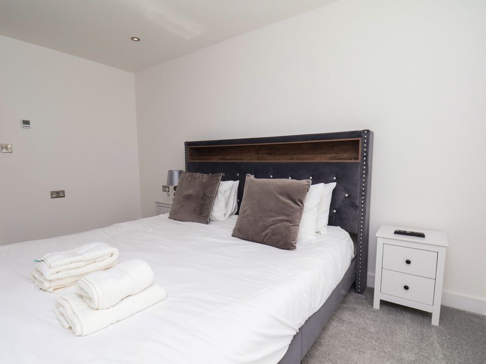 A bedroom with a bed and towels at Meadow View Beverley near Walkington