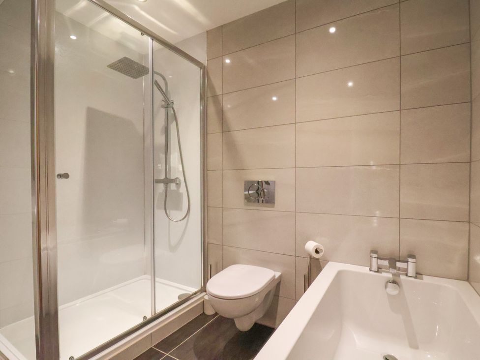 A bathroom with a shower, bathtub, and toilet at Meadow View in Beverley near Walkington