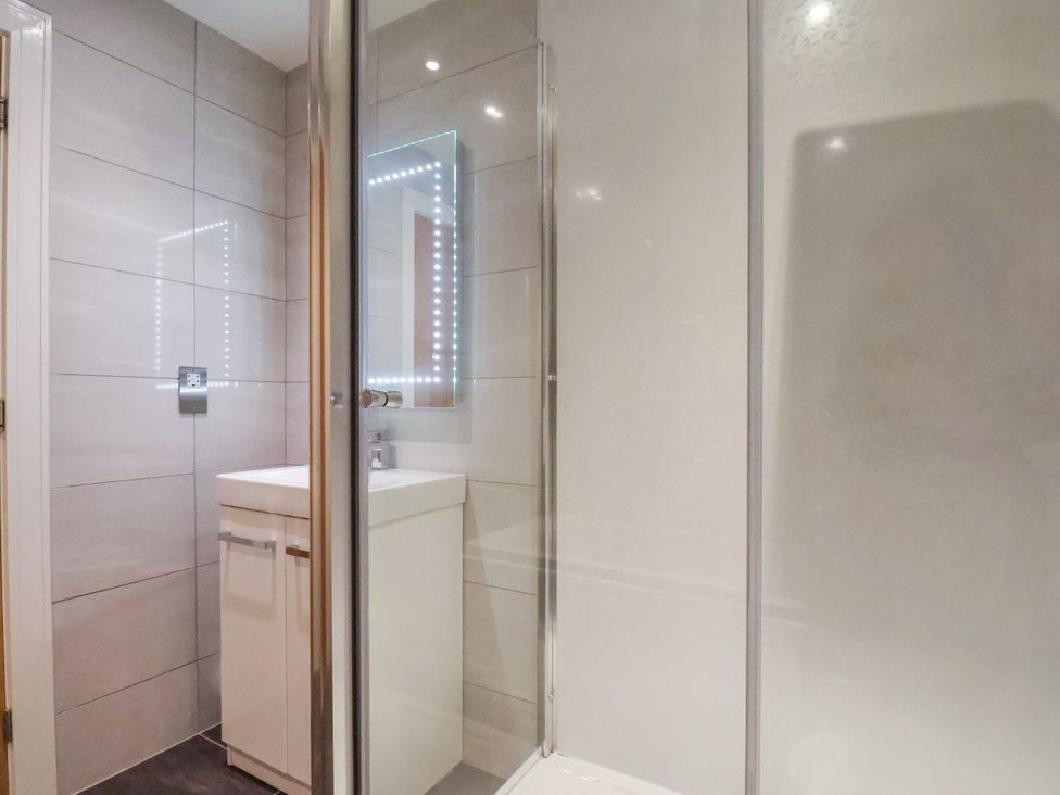 A bathroom featuring a shower and a vanity unit at Meadow View Beverley near Walkington