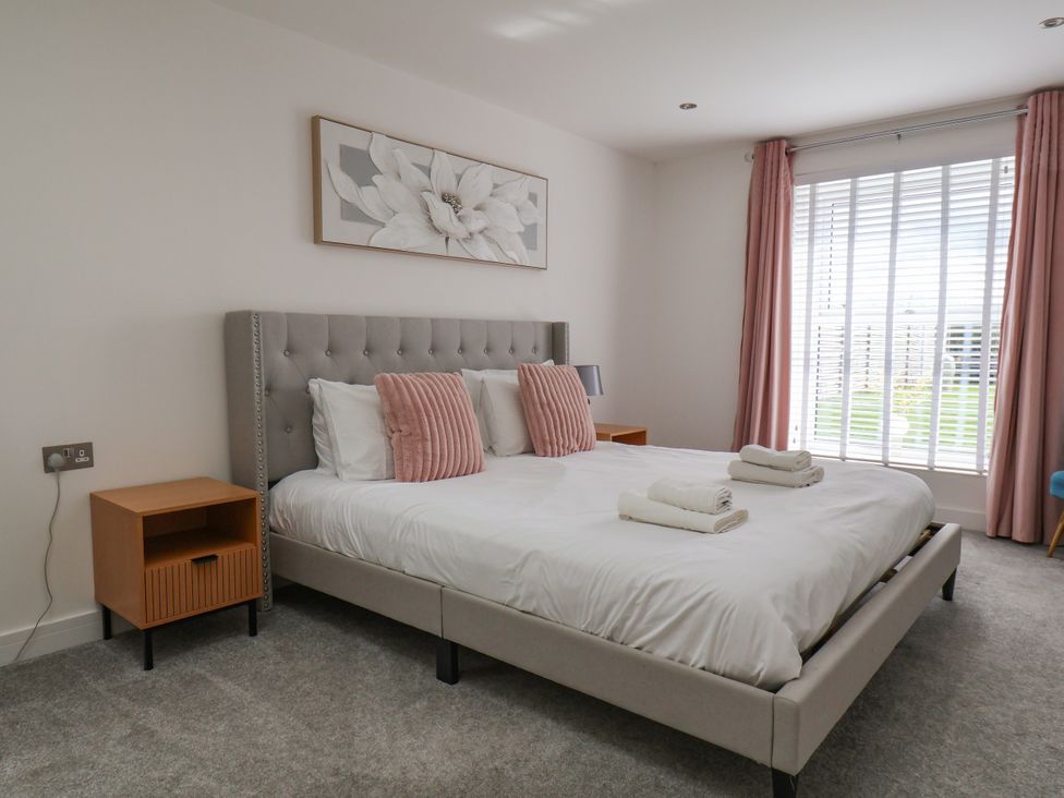 A bedroom with a bed and bedside table at Meadow View Beverley near Walkington