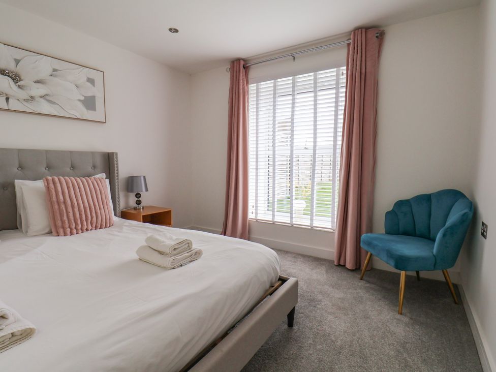 A bedroom with a bed and a chair at Meadow View in Beverley near Walkington