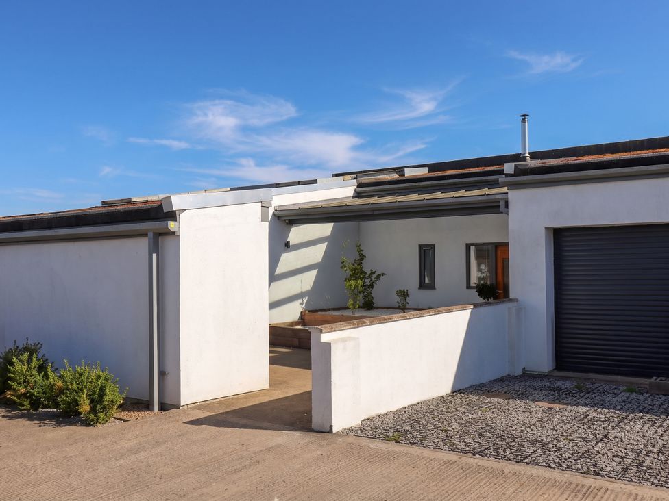 An exterior view of a house with a driveway and garage at Meadow View Beverley near Walkington