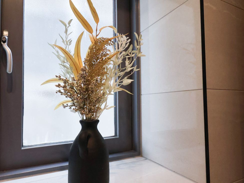 A vase with flowers near a window at Meadow View Beverley near Walkington