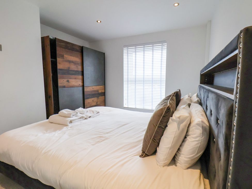 A bedroom with a bed and wardrobe at Meadow View Beverley near Walkington