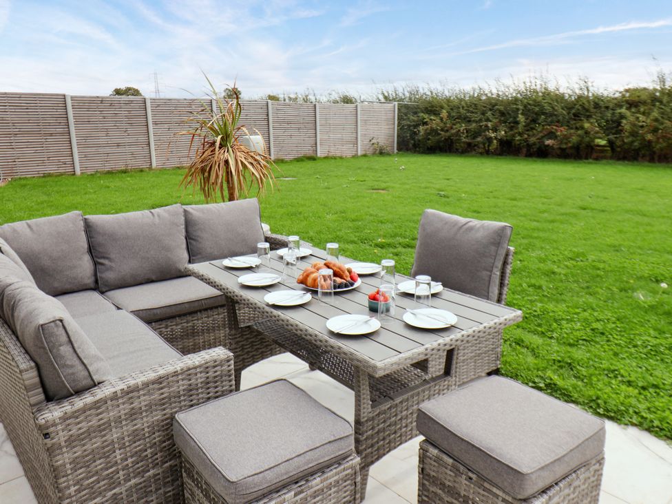 An outdoor dining area with furniture in the garden at Meadow View Beverley near Walkington