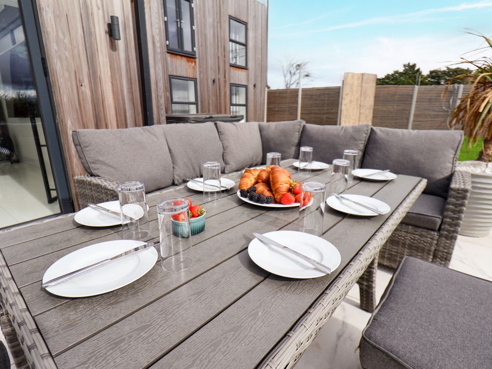 An outdoor dining area with a table set for breakfast at Meadow View Beverley near Walkington