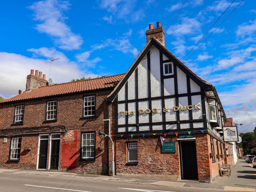 A pub building with signage and decorations at The Dog & Duck in Beverley near Walkington