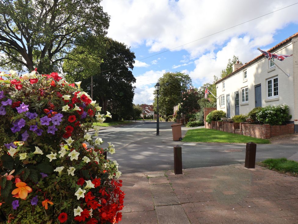 A street view with flowers and houses at Meadow View Beverley near Walkington