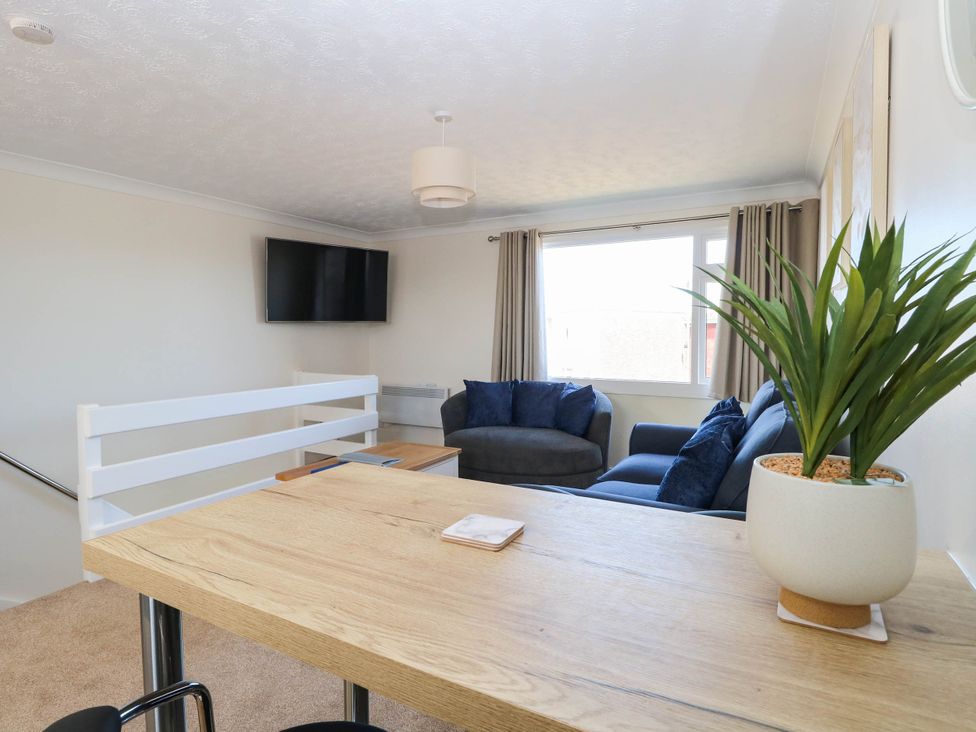A living room with a sofa and television at 158 Beach Road Chalet Park