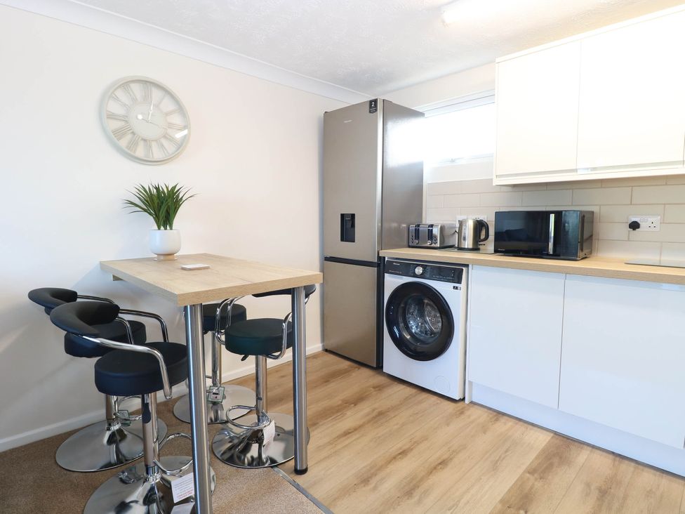A kitchen with appliances and seating at 158 Beach Road Chalet Park