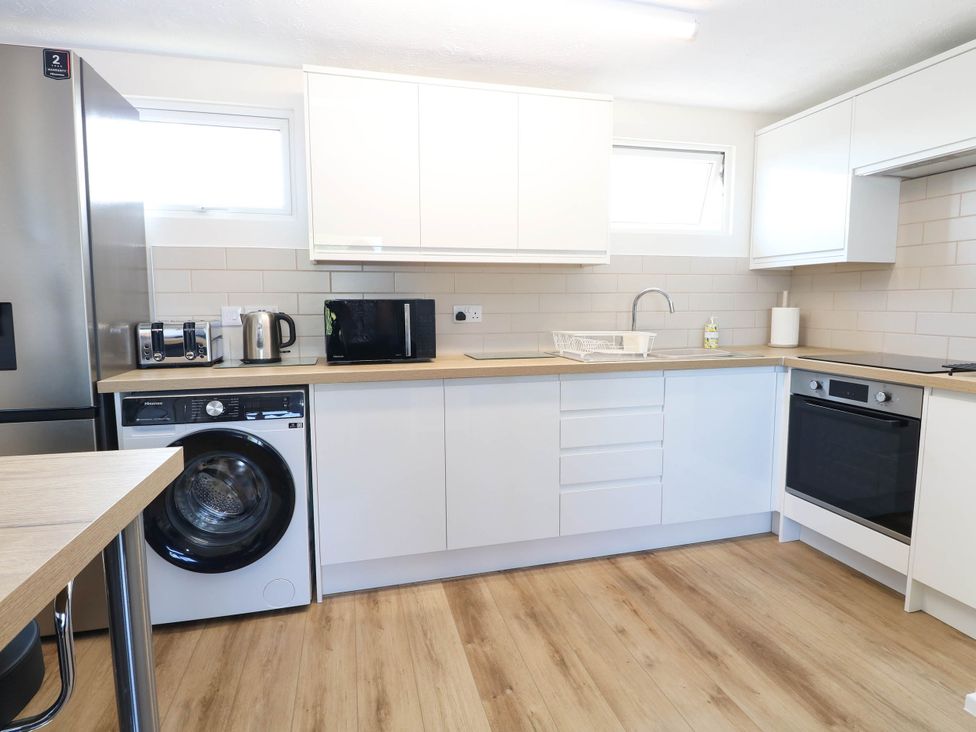A kitchen with a refrigerator and washing machine at 158 Beach Road Chalet Park