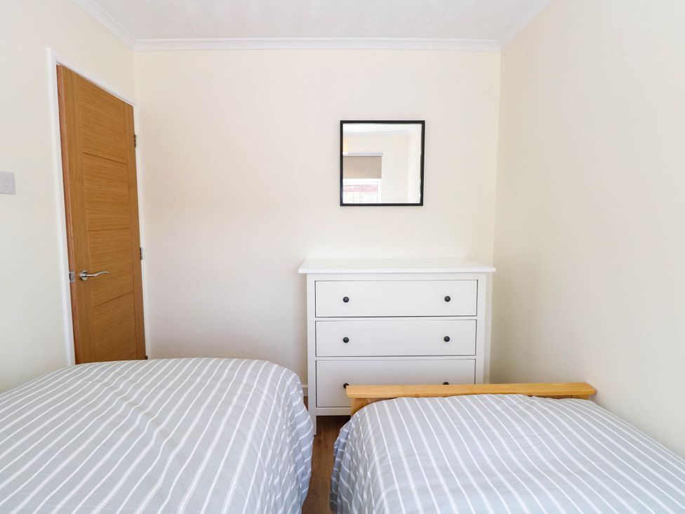 A bedroom with two beds and a dresser at 158 Beach Road Chalet Park