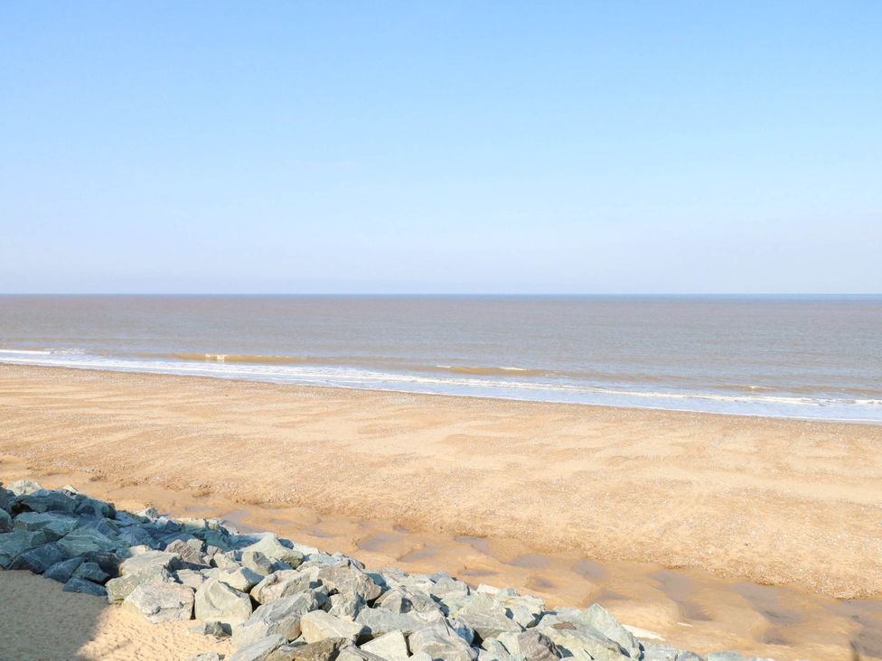 A beach view with sand and ocean waves at 158 Beach Road Chalet Park
