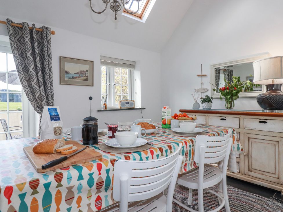 A kitchen with a table set for breakfast at Ivy Cottage in Trenale near Tintagel