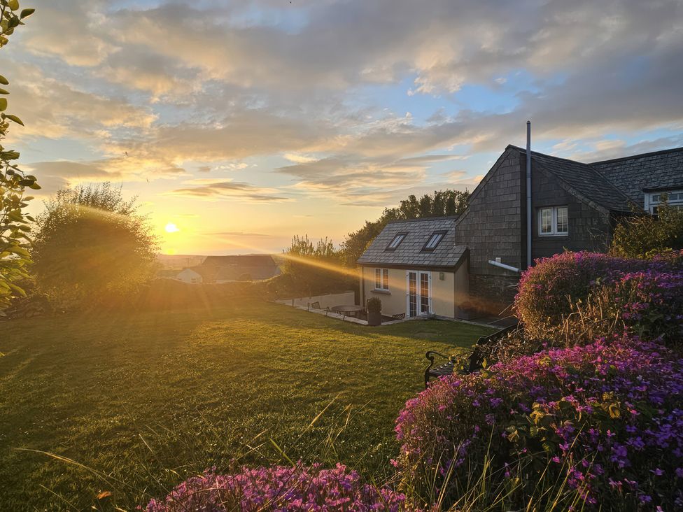A house with garden and sunset at Ivy Cottage Trenale near Tintagel