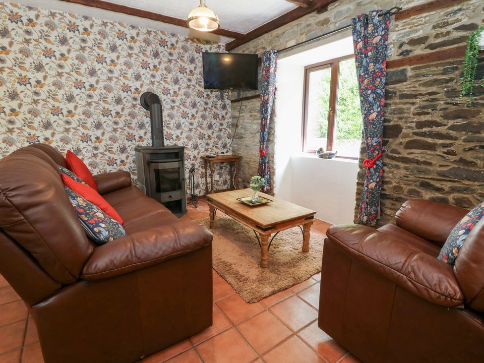 A living room with a sofa and coffee table at The Stable in Llandysul