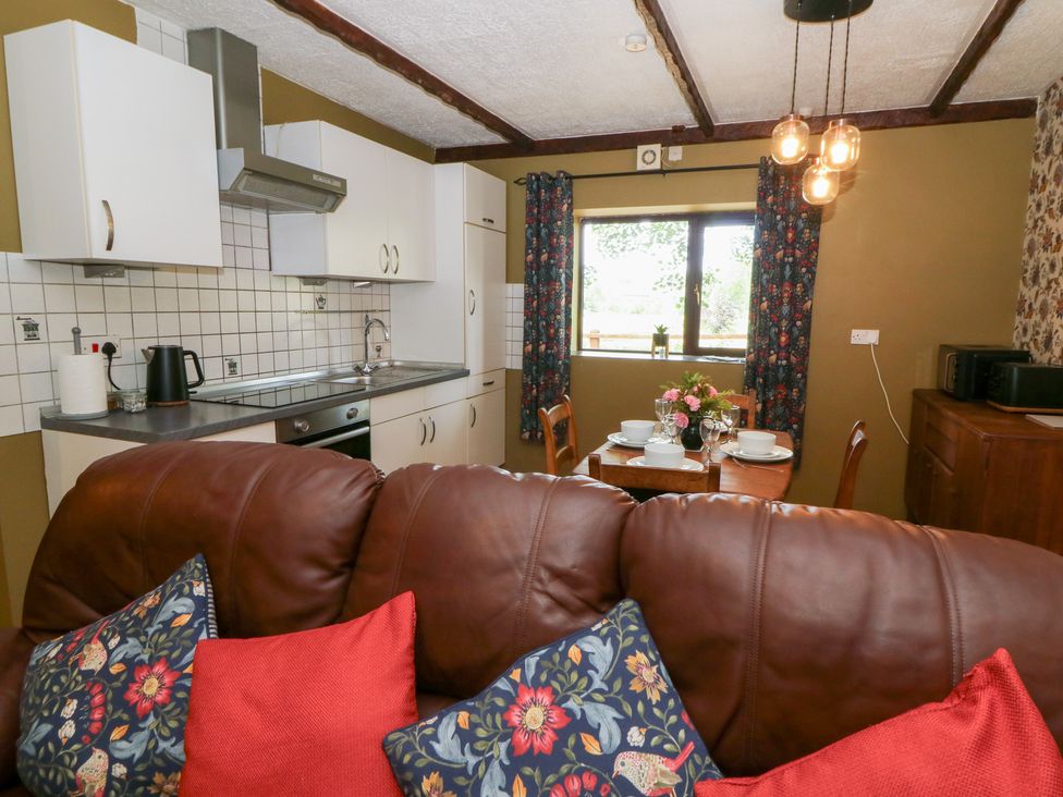 A kitchen with a dining area at The Stable in Llandysul