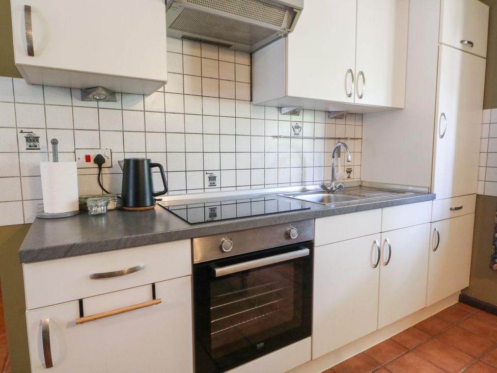 A kitchen with a sink and oven at The Stable in Llandysul