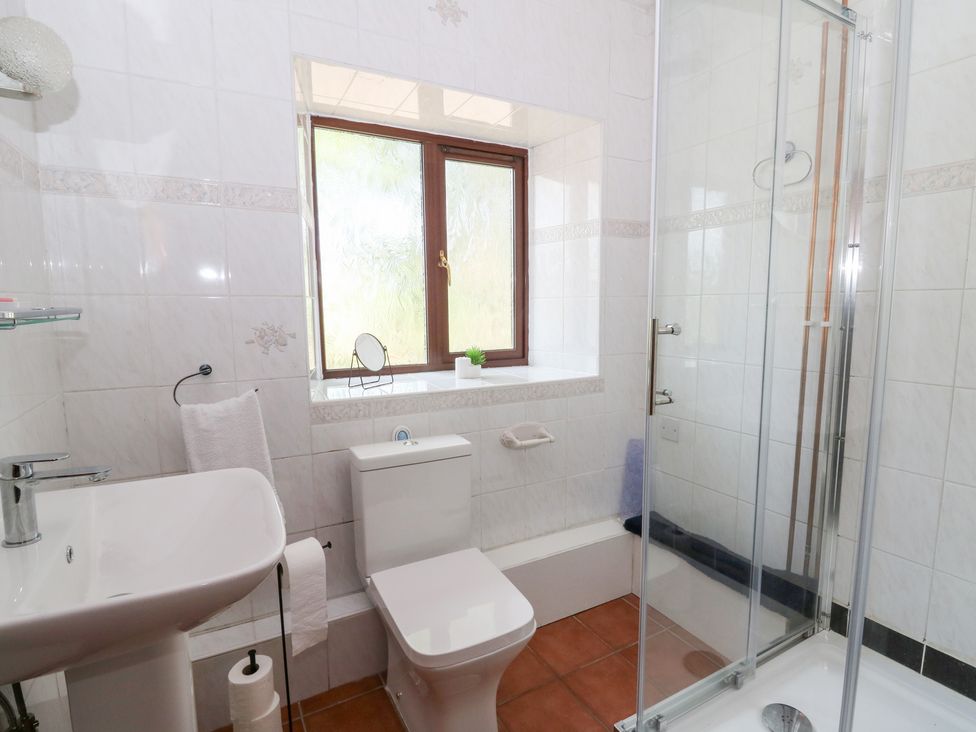 A bathroom with a sink and shower at The Stable in Llandysul