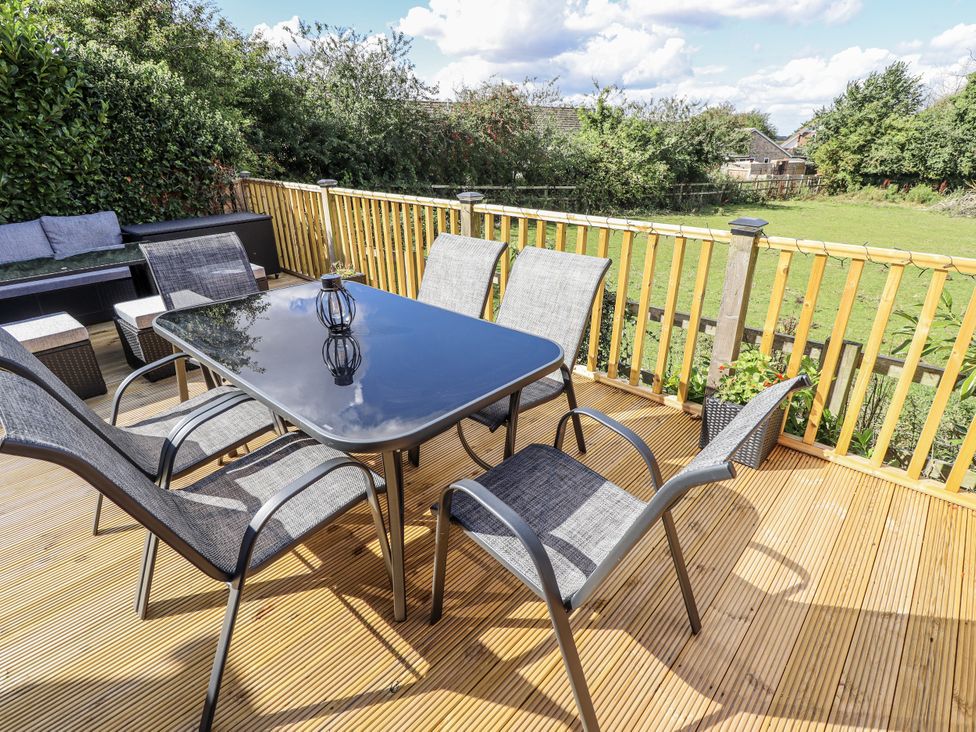 An outdoor dining area with a table and chairs at Church View in Withernwick near Aldbrough