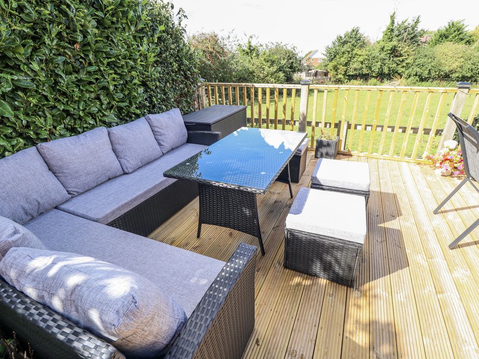 An outdoor seating area with a sofa and table at Church View in Withernwick near Aldbrough