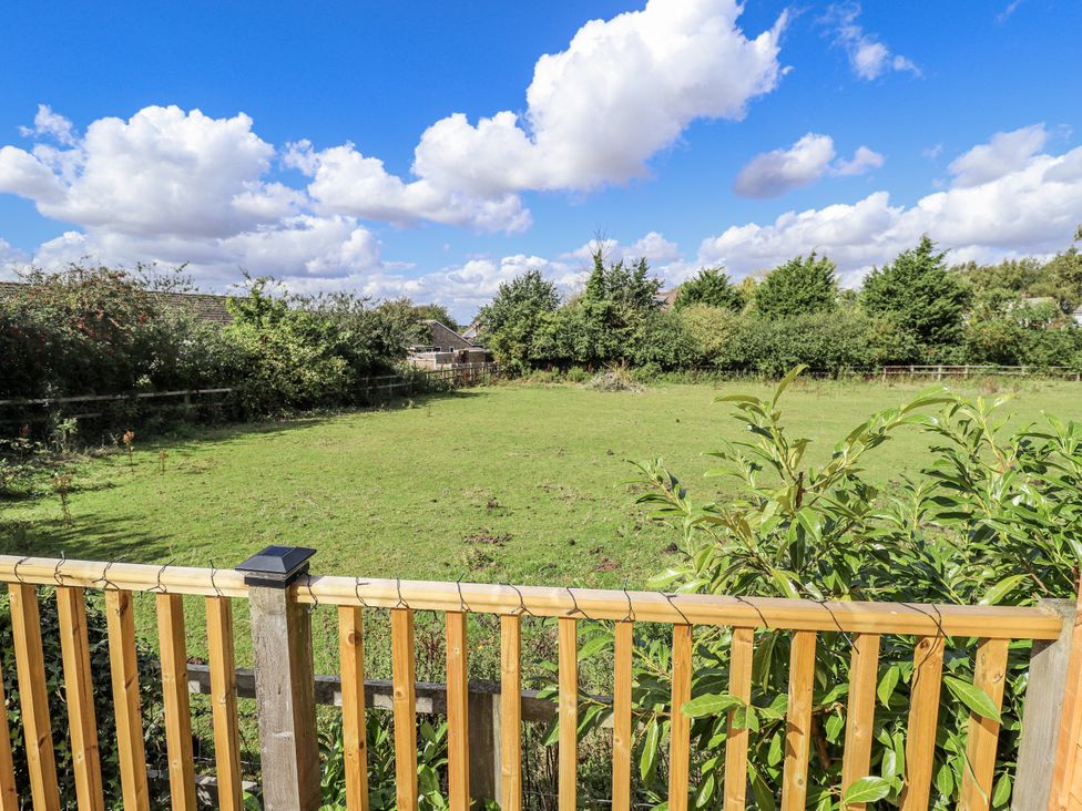A garden with grass and trees at Church View in Withernwick near Aldbrough