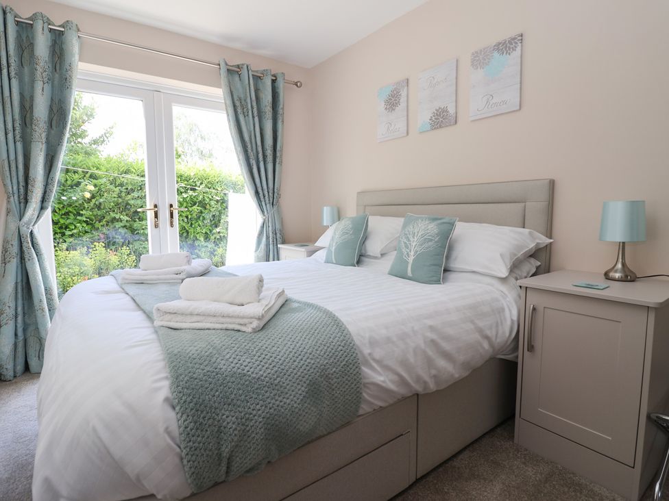 A bedroom with a double bed and bedside tables at Church View in Withernwick near Aldbrough