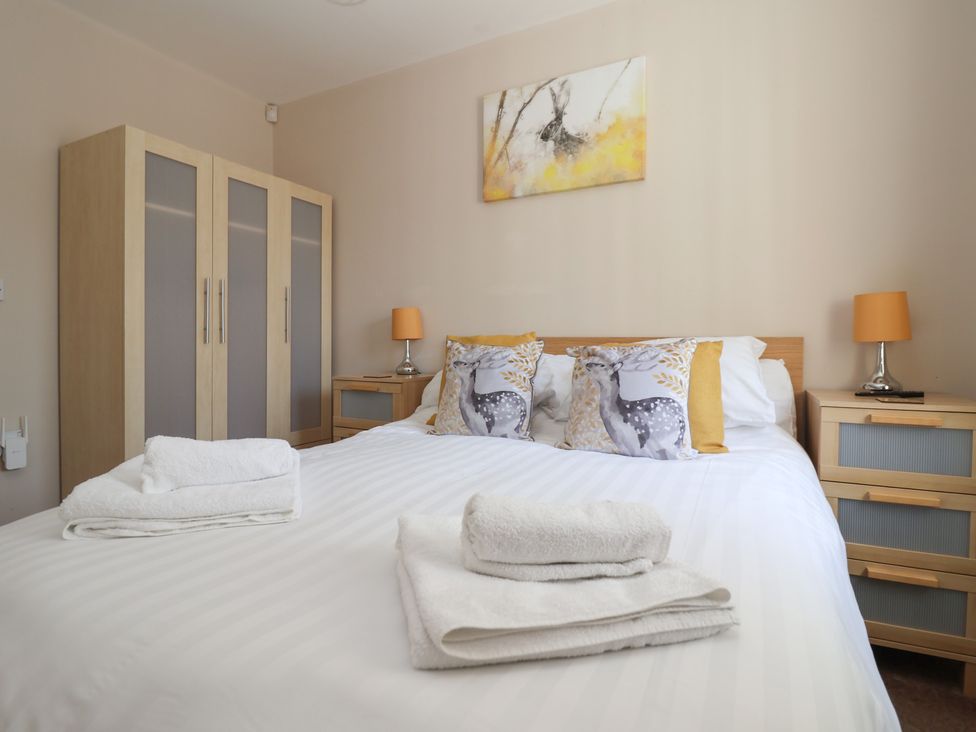 A bedroom with a bed and wardrobe at Church View in Withernwick near Aldbrough