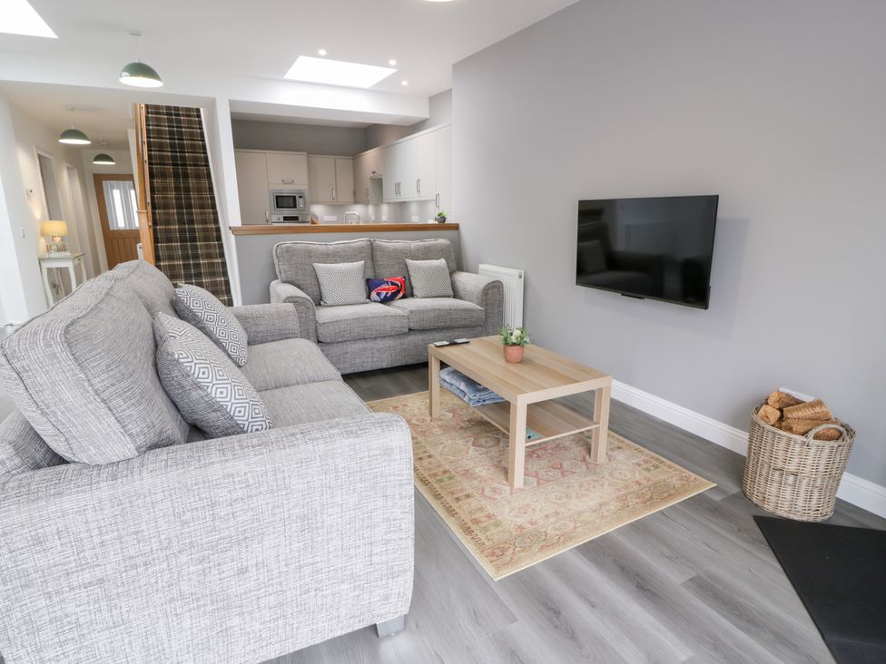 A living room with a sofa and coffee table at Beach House in Stranraer
