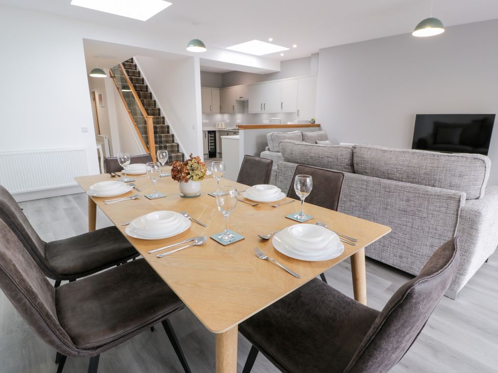 A dining room with a table set for dinner at Beach House in Stranraer