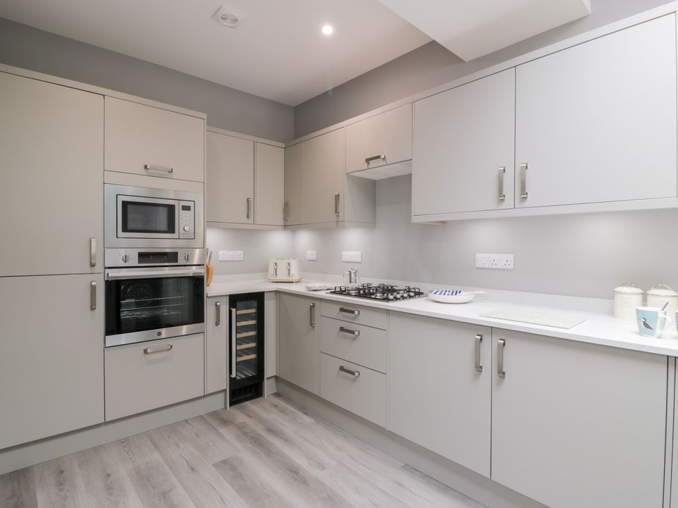 A kitchen with an oven and microwave at Beach House Stranraer