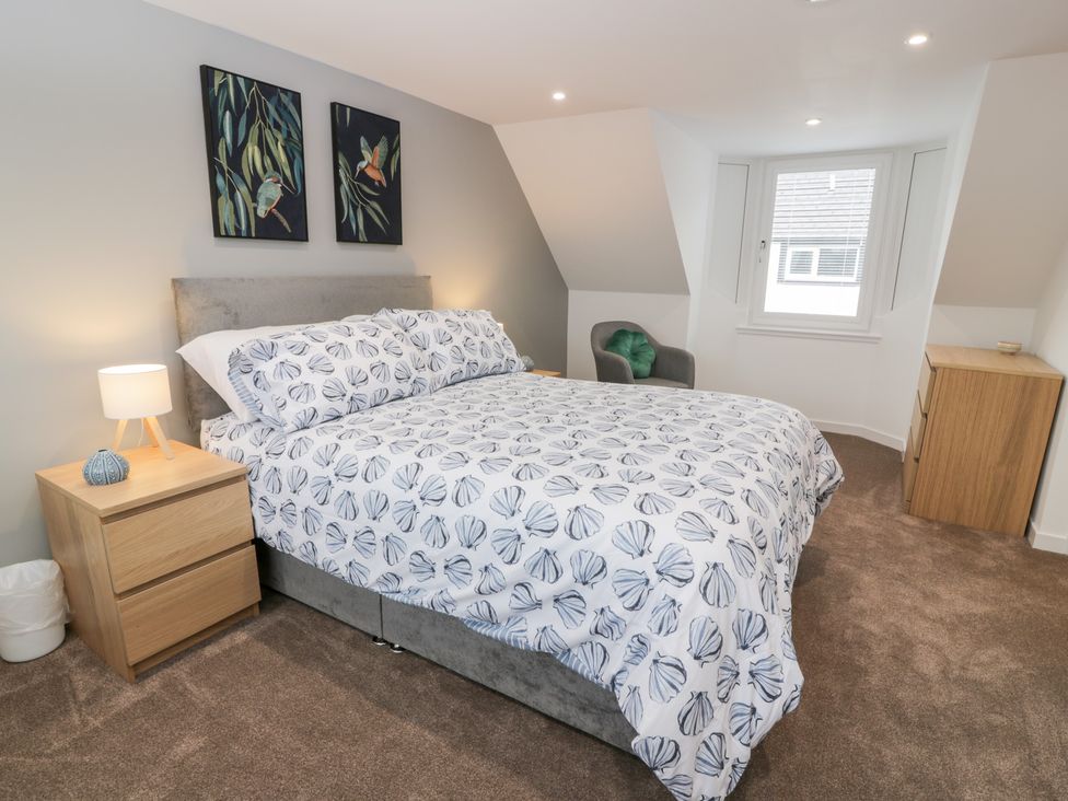 A bedroom with a bed and bedside table at Beach House in Stranraer