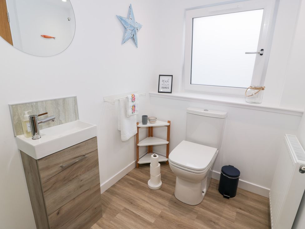 A bathroom with a wash basin and toilet at Beach House in Stranraer
