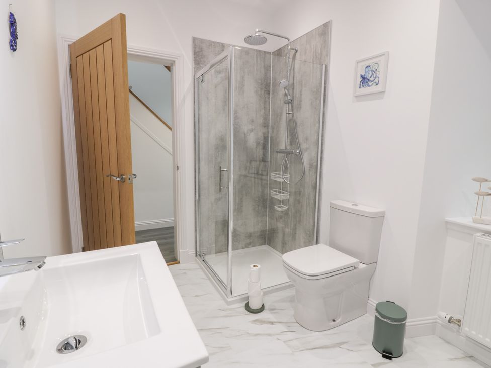A bathroom with a shower and sink at Beach House in Stranraer