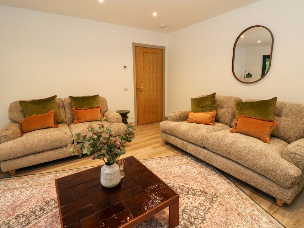 A living room with two sofas and a coffee table at Nevis Bridge House in Fort William