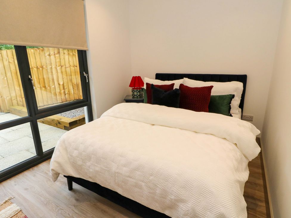 A bedroom with a bed and pillows at Nevis Bridge House in Fort William