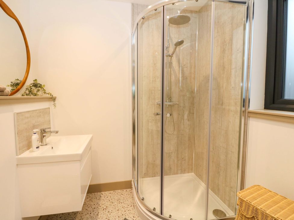 A bathroom with a shower and a sink at Nevis Bridge House Fort William