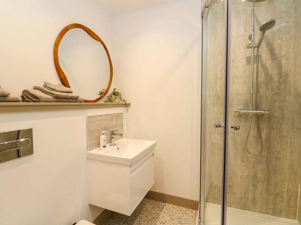 A bathroom with a shower and sink at Nevis Bridge House in Fort William