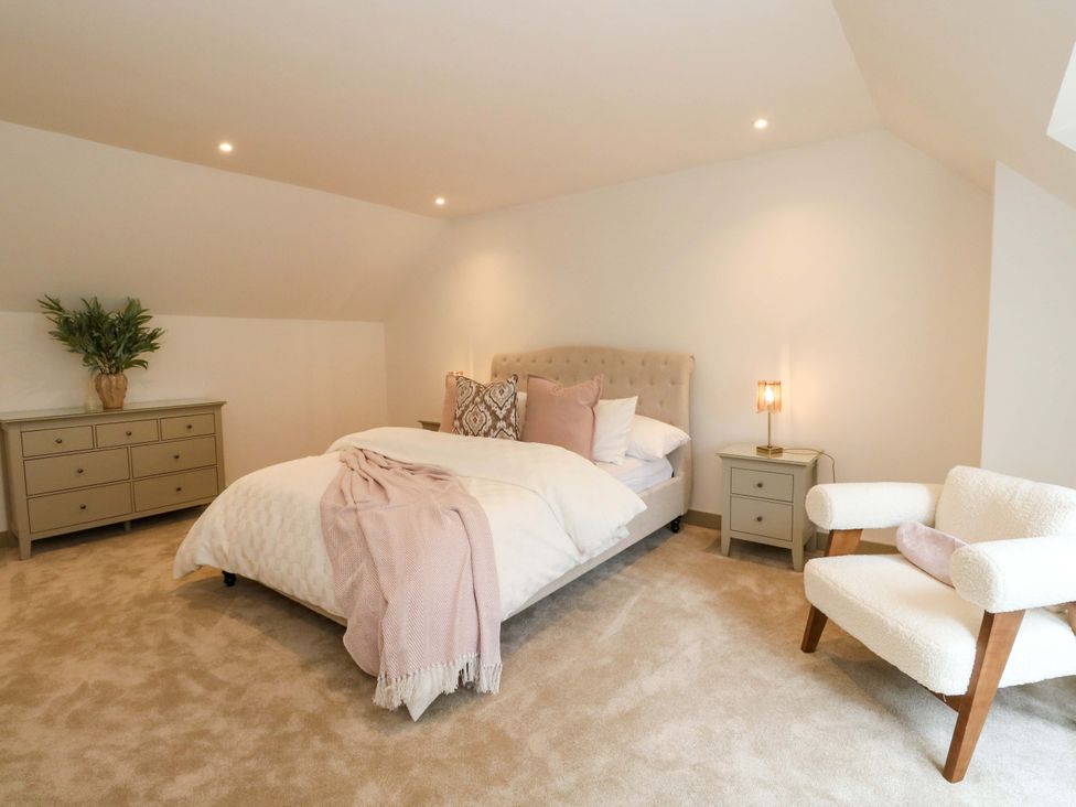 A bedroom with a bed and dresser at Nevis Bridge House in Fort William