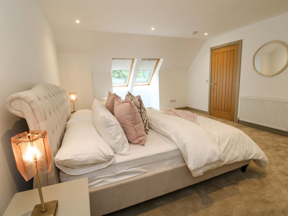 A bedroom with a bed and pillows at Nevis Bridge House in Fort William
