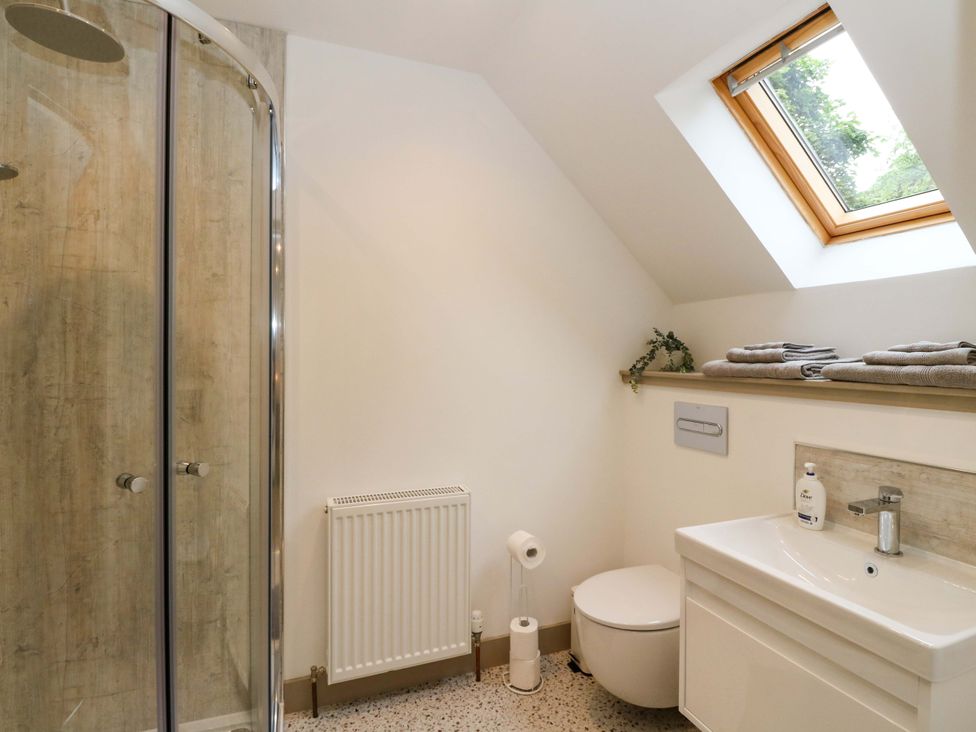 A bathroom with a shower toilet and sink at Nevis Bridge House Fort William