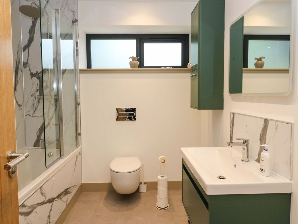 A bathroom with a shower, sink, and toilet at Nevis Bridge House, Fort William