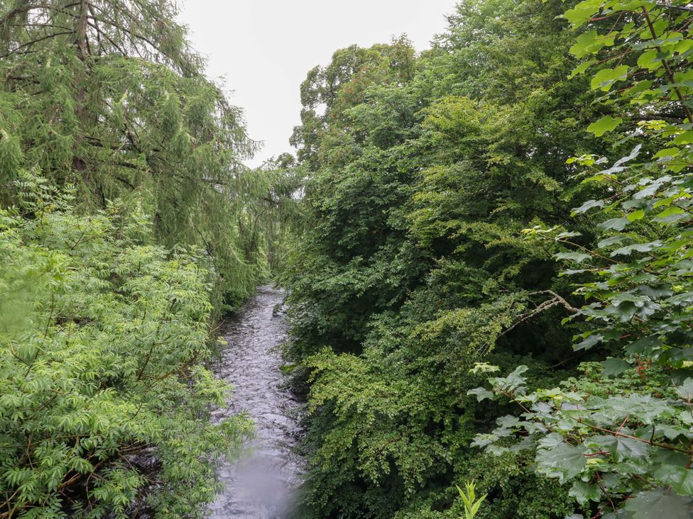 A view of a river surrounded by trees at Nevis Bridge House in Fort William