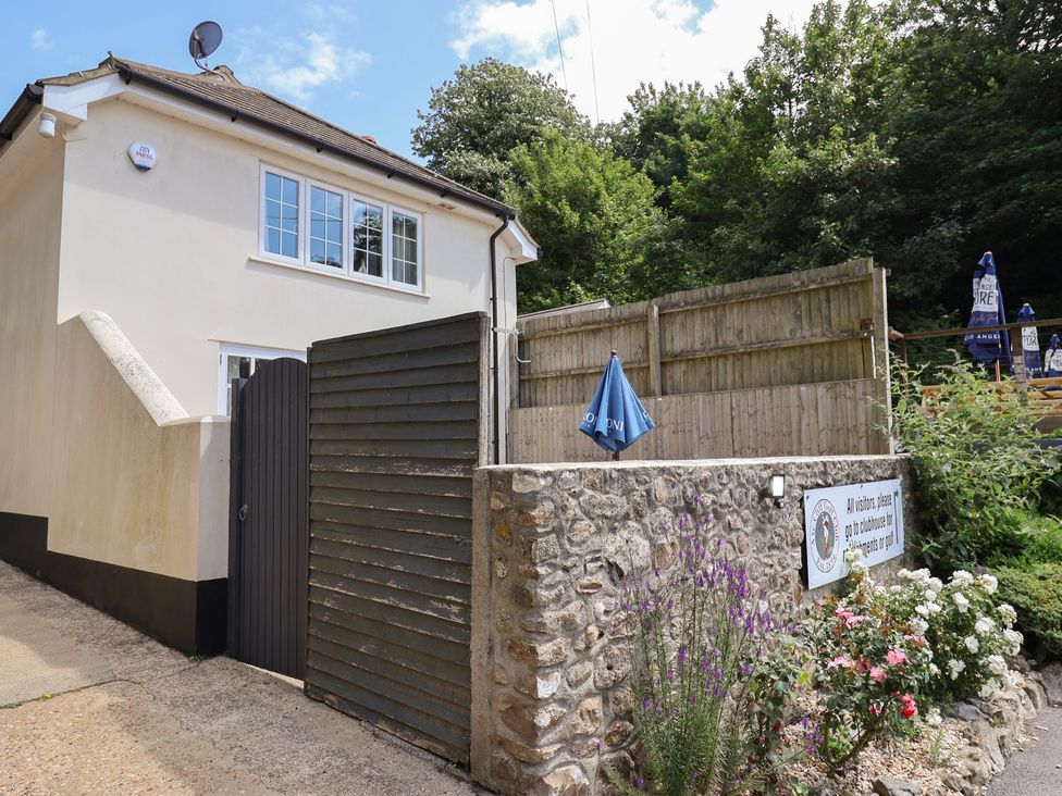 An outdoor area with a gate and flowers at Fairview House in Axmouth