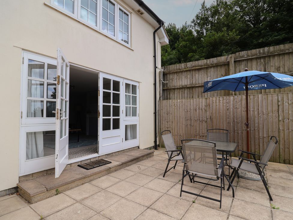 An outdoor patio with a table and chairs at Fairview House in Axmouth