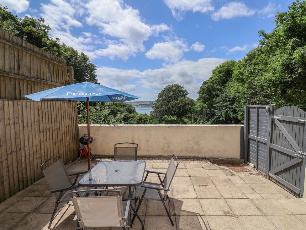 An outdoor patio with a table and chairs at Fairview House in Axmouth