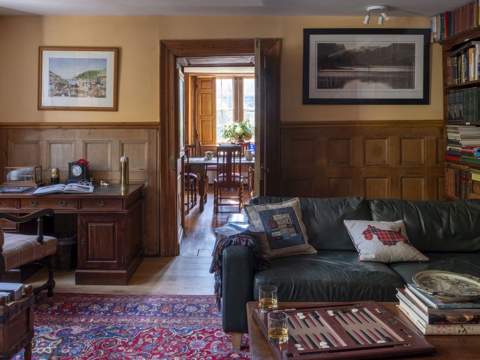 A living room with a sofa and coffee table at Manor Farmhouse in Dittisham