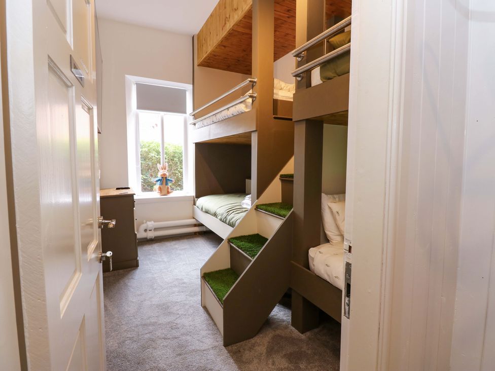 A bedroom with bunk beds and a window at The Miners Hall Retreat in Stanley, County Durham