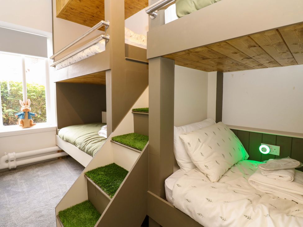 A bedroom with bunk beds and a toy at The Miners Hall Retreat in Stanley, County Durham